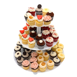 A tiered display of various mini cupcakes with different flavors and toppings, arranged for serving at an event.